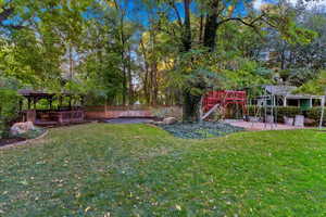 View of yard featuring a playground and a gazebo