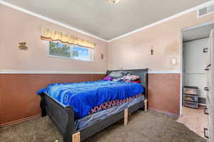 Carpeted bedroom with ornamental molding