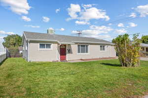 Ranch-style home featuring a front lawn