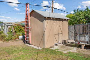 View of outdoor structure with a lawn