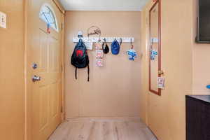 Doorway featuring light hardwood / wood-style flooring and wood walls