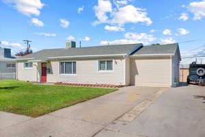 Ranch-style house with central AC unit, a front yard, and a garage