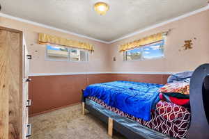 Bedroom featuring ornamental molding and carpet