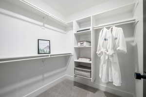 Walk in closet with carpet flooring