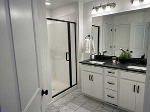 Master Bathroom featuring an enclosed shower and vanity