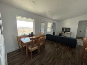 Dining room featuring vaulted ceiling, a textured ceiling, and dark hardwood / wood-style floors