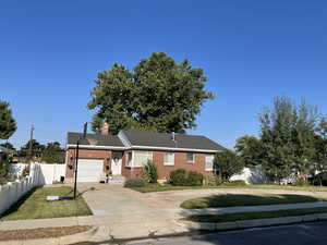 Single story home featuring a garage and a front lawn