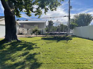 View of yard with a trampoline