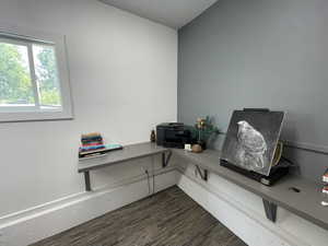 Home office with dark wood-type flooring