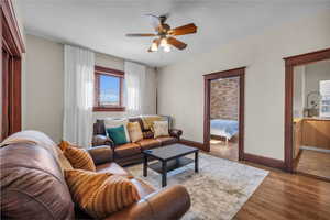 Living room featuring light hardwood / wood-style floors and ceiling fan