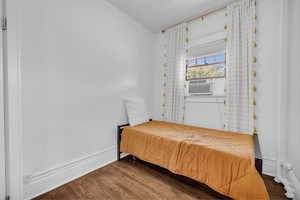 Bedroom with hardwood / wood-style flooring