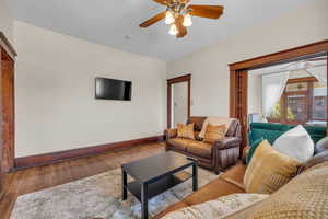 Living room featuring light hardwood / wood-style floors and ceiling fan