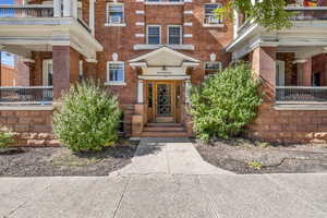 View of exterior entry with a balcony