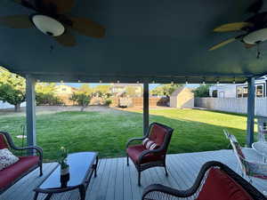 Exterior space featuring a storage unit, ceiling fan, and a wooden deck