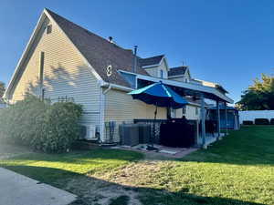 Back of house featuring a yard,