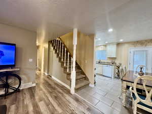 Living room featuring light hardwood / wood-style flooring, a textured ceiling,