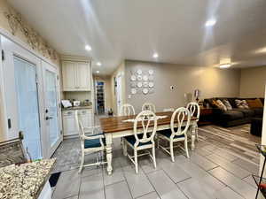 Dining room with light hardwood / wood-style flooring and french doors