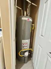 Utility room with gas water heater and washer / dryer