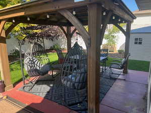 View of patio / terrace with a shed and a gazebo