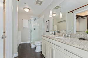 Full bathroom featuring vanity, separate shower and tub, toilet, and tile patterned floors