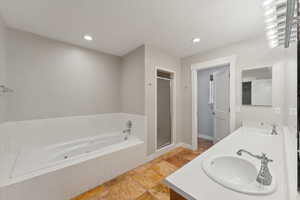 Bathroom with vanity and separate shower and tub