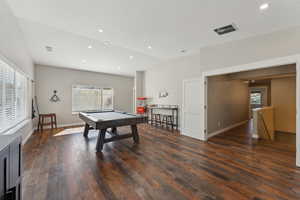 Rec room featuring lofted ceiling, pool table, dark hardwood / wood-style floors, and a healthy amount of sunlight