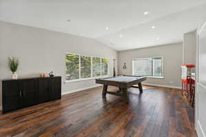 Rec room featuring pool table, vaulted ceiling, dark hardwood / wood-style flooring, and a wealth of natural light