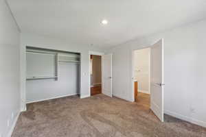 Unfurnished bedroom featuring carpet and a closet