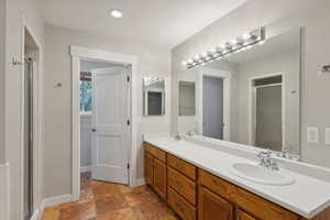 Bathroom with vanity and a shower with door