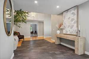 Hallway with dark hardwood / wood-style flooring