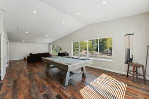 Game room featuring vaulted ceiling, dark wood-type flooring, and billiards