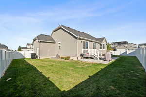 Rear view of property with a yard and a patio