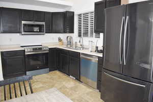 Kitchen with appliances with stainless steel finishes and sink