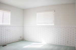 Spare room featuring carpet floors and a textured ceiling