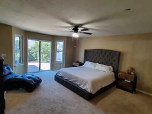 Bedroom featuring access to outside, ceiling fan, and light colored carpet