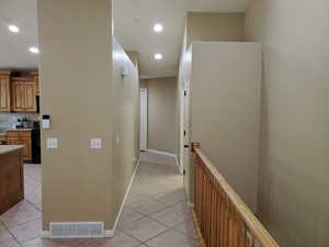 Hall featuring light tile patterned flooring