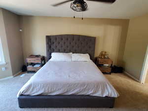 Carpeted bedroom featuring ceiling fan