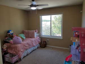 Carpeted bedroom with ceiling fan