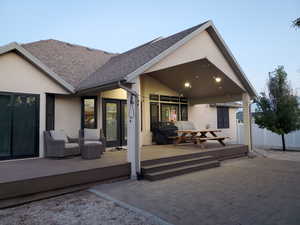 Rear view of house with covered trex deck and a patio area