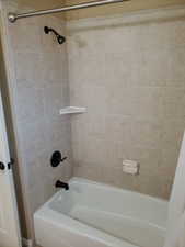 Bathroom featuring tiled shower / bath