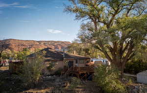 Back of property featuring a deck with mountain view