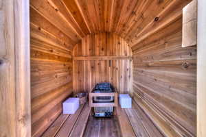 View of sauna / steam room featuring wooden walls, hardwood / wood-style floors, and wooden ceiling