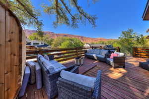 Wooden deck featuring a mountain view and an outdoor hangout area