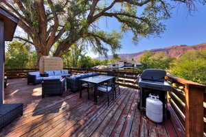 Deck featuring a mountain view and an outdoor living space