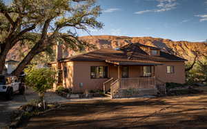 View of front of home featuring a mountain view and a porch