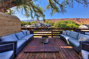 Wooden deck featuring a mountain view and an outdoor hangout area