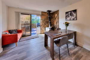 Dining space featuring wood-type flooring and a wood stove