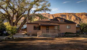 View of front of home featuring a mountain view and a porch