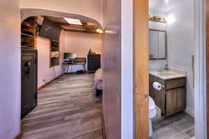 Hall featuring hardwood / wood-style flooring and sink