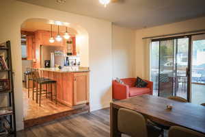 Dining area with dark hardwood / wood-style flooring